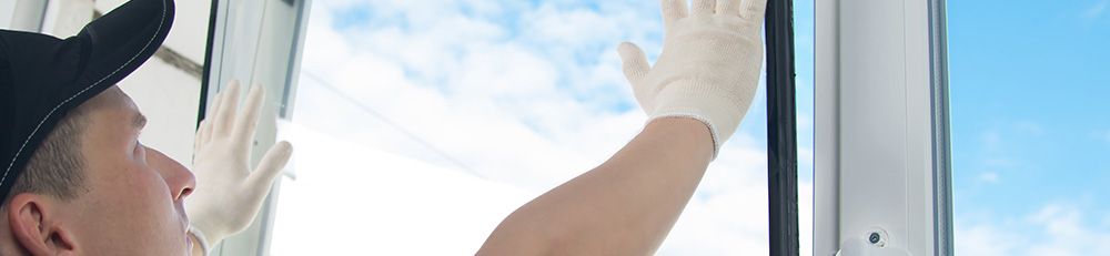 man replacing window pane